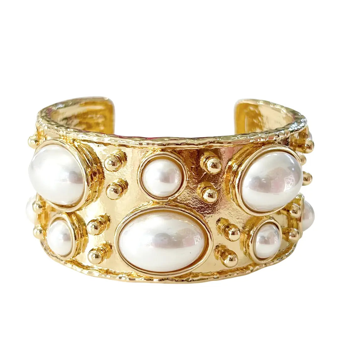Gold bracelet with pearls on a white background