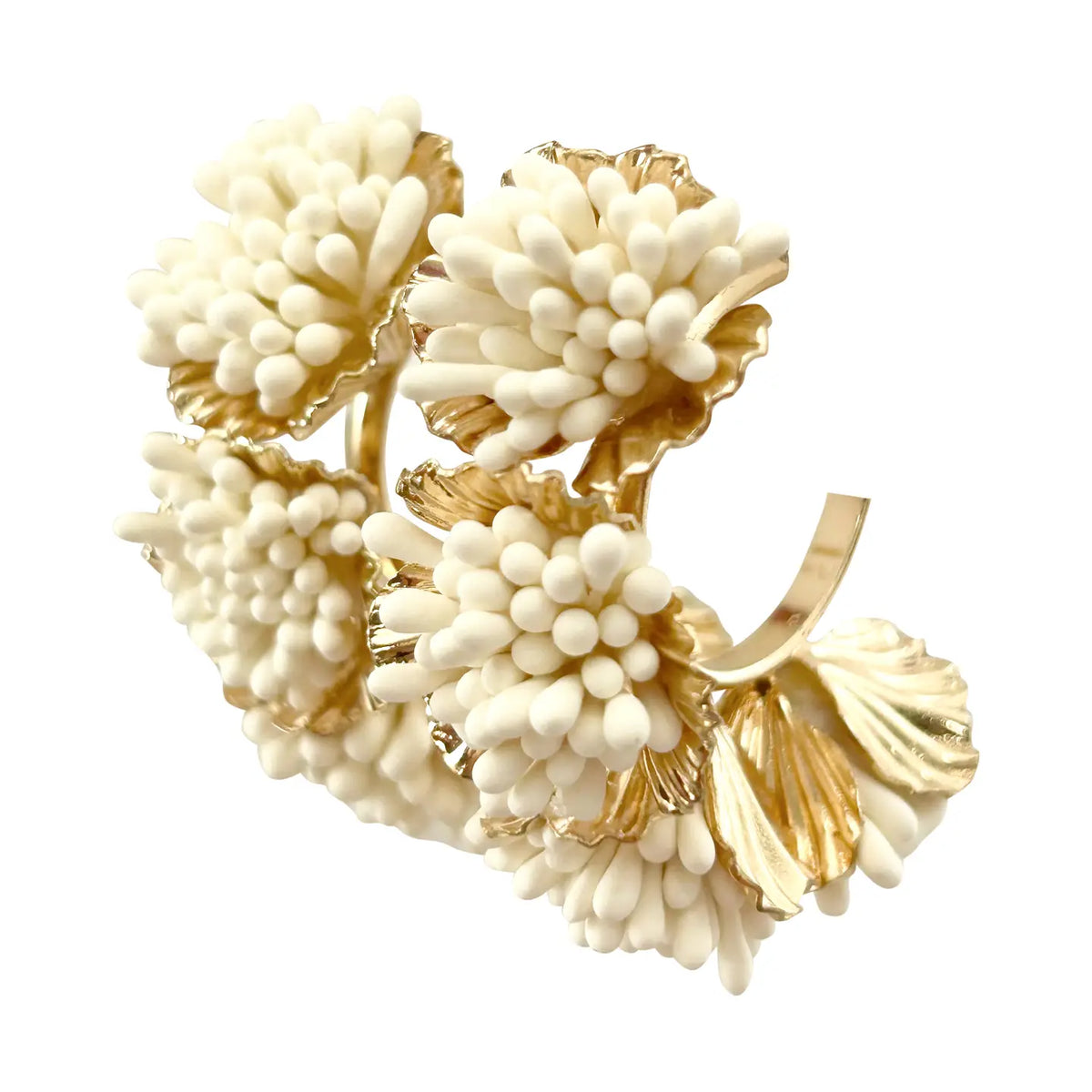 Gold and white coral-like jewelry piece on a white background