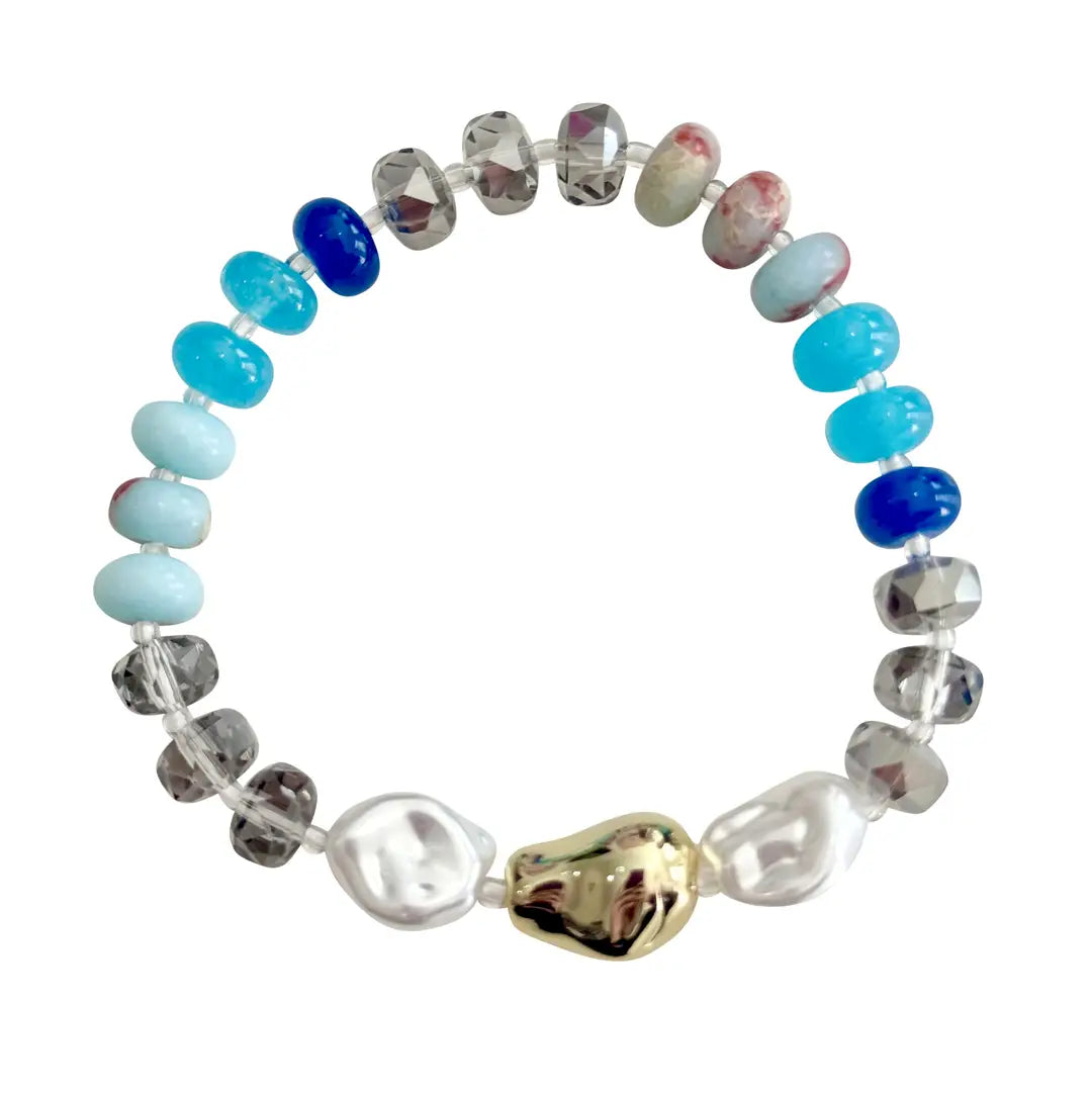 Multicolored beaded bracelet with a gold accent on a white background