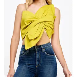 Woman wearing a yellow top and blue jeans on a white background