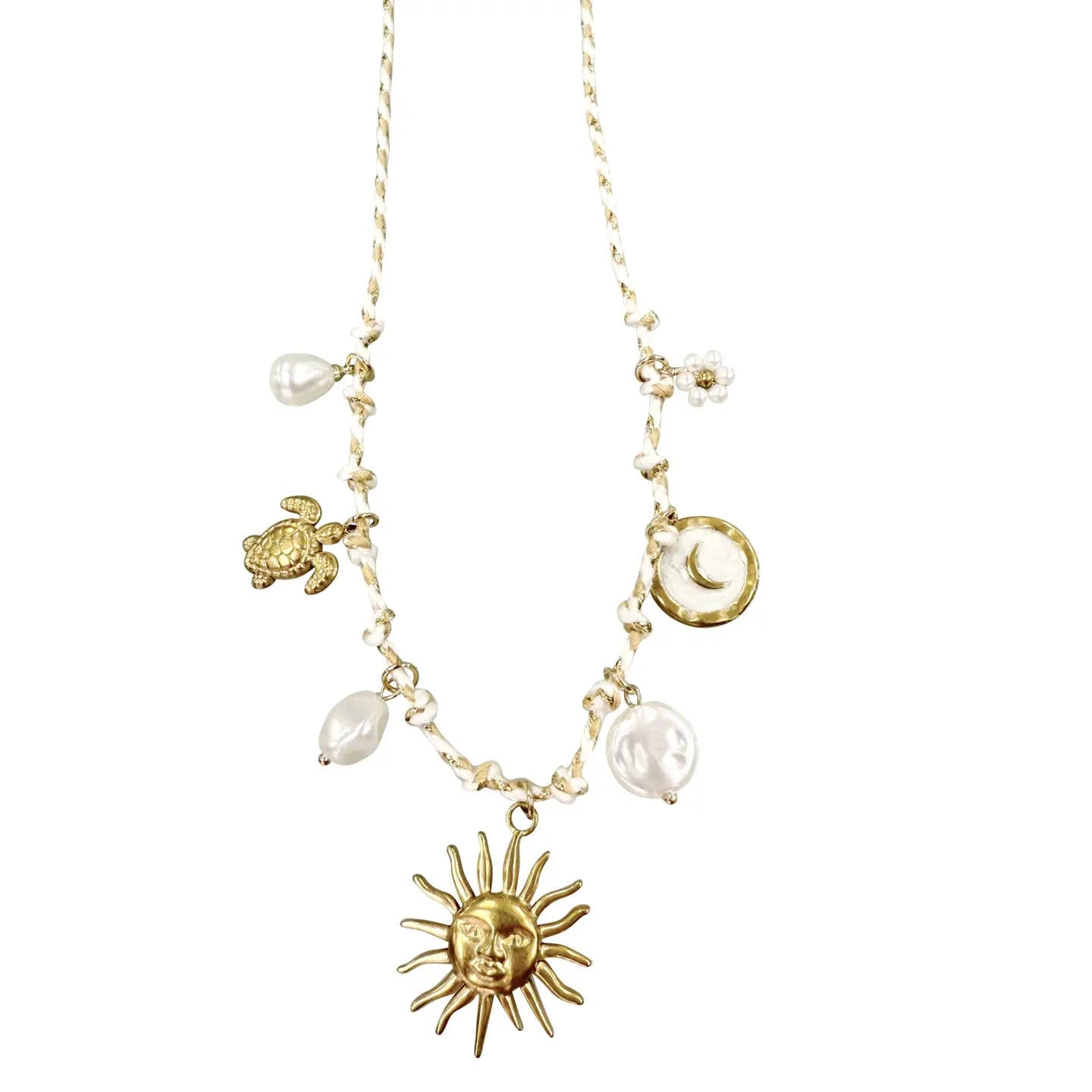 Gold necklace with sun, turtle, and moon charms on a white background