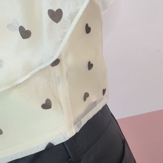 Gia Ruffle Heart Printed Top - The Spark Boutique Gia ruffle top with heart print pattern and delicate ruffle details, close up