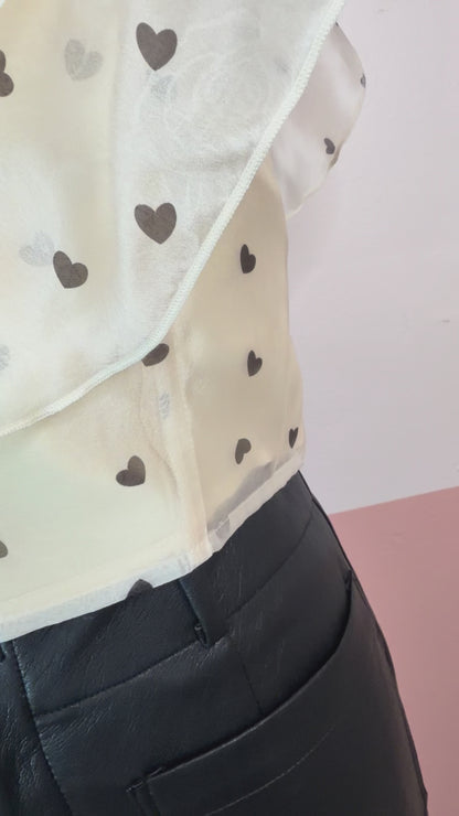 Gia Ruffle Heart Printed Top - The Spark Boutique Gia ruffle top with heart print pattern and delicate ruffle details, close up