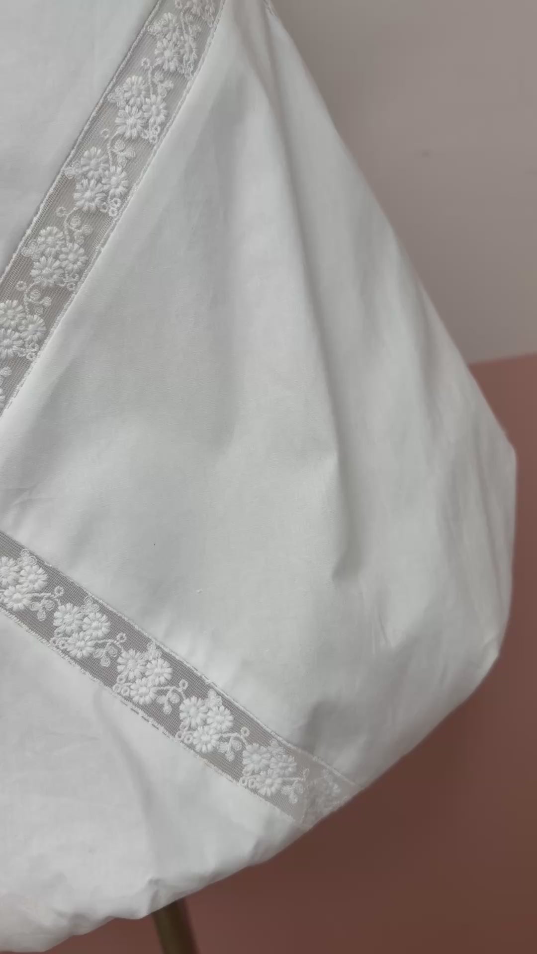 White lace top and skirt set on a mannequin against a plain background.Bubble hem crop top with delicate lace trim neckline detail. The Spark Boutique| West Palm Beach